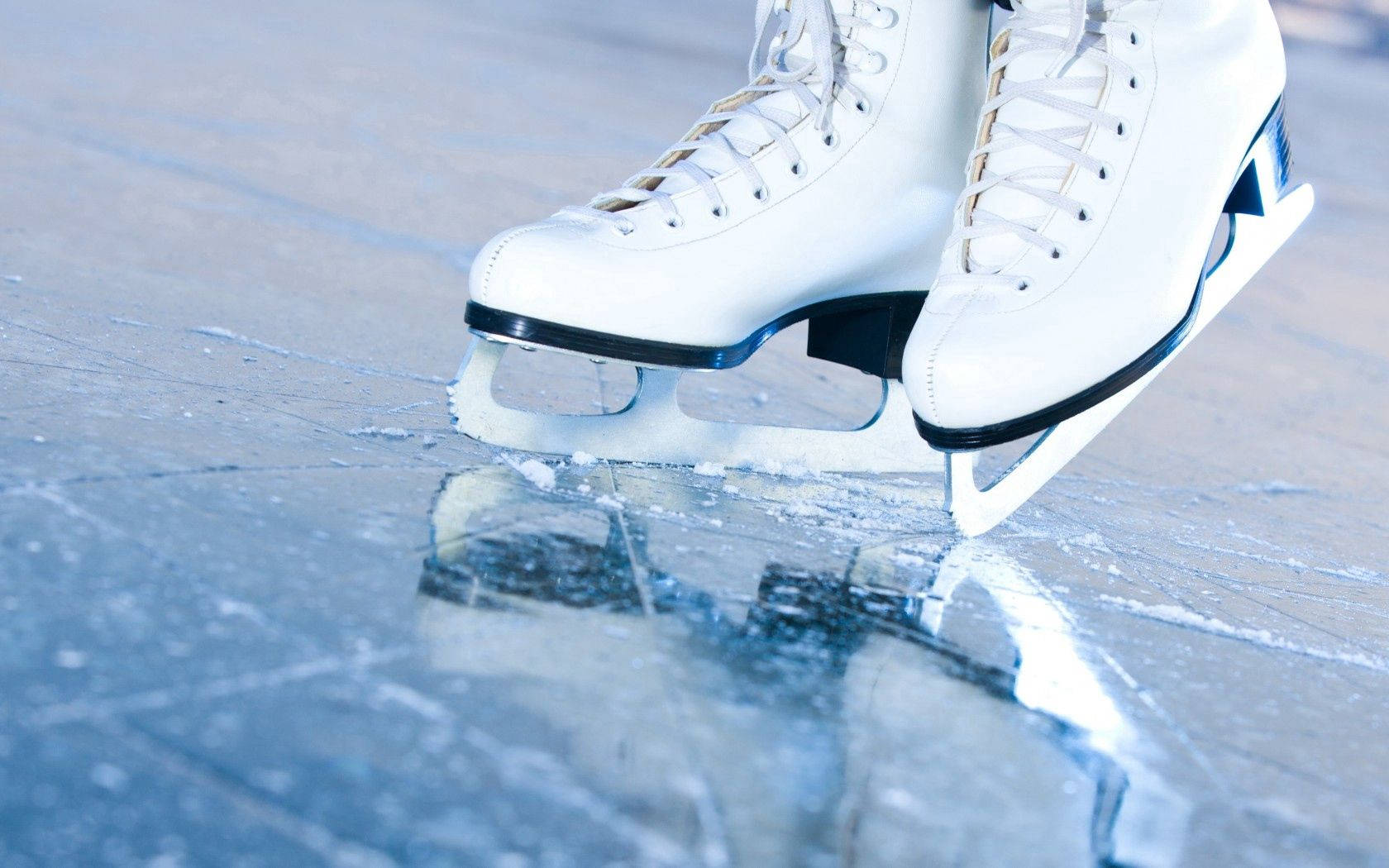White Figure Skates On Ice