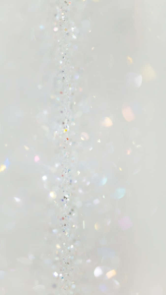 A White Background With A Lot Of Sparkles Wallpaper