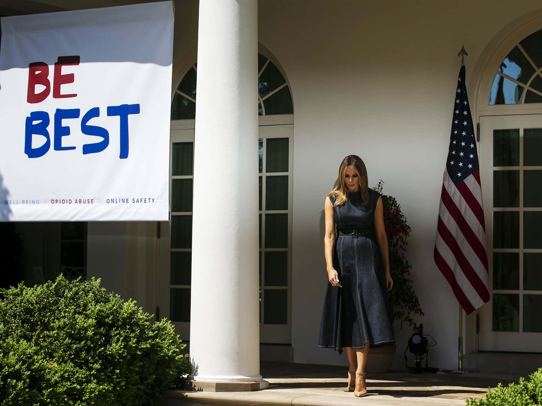 Melania Trump Stands In Front Of A Banner That Says Be Best