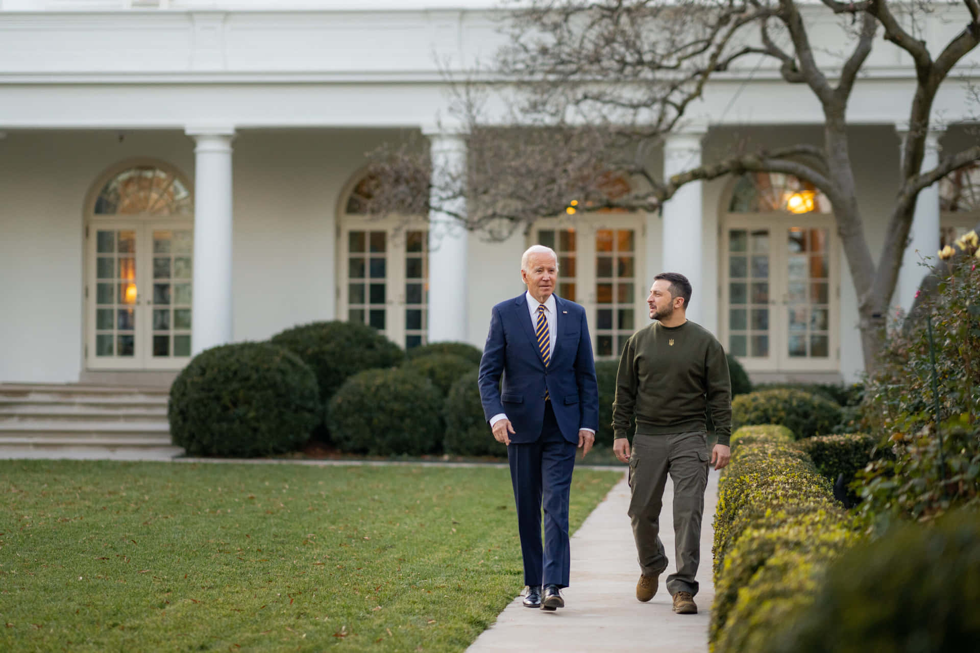 Two Men Walking Down The Path Of The White House