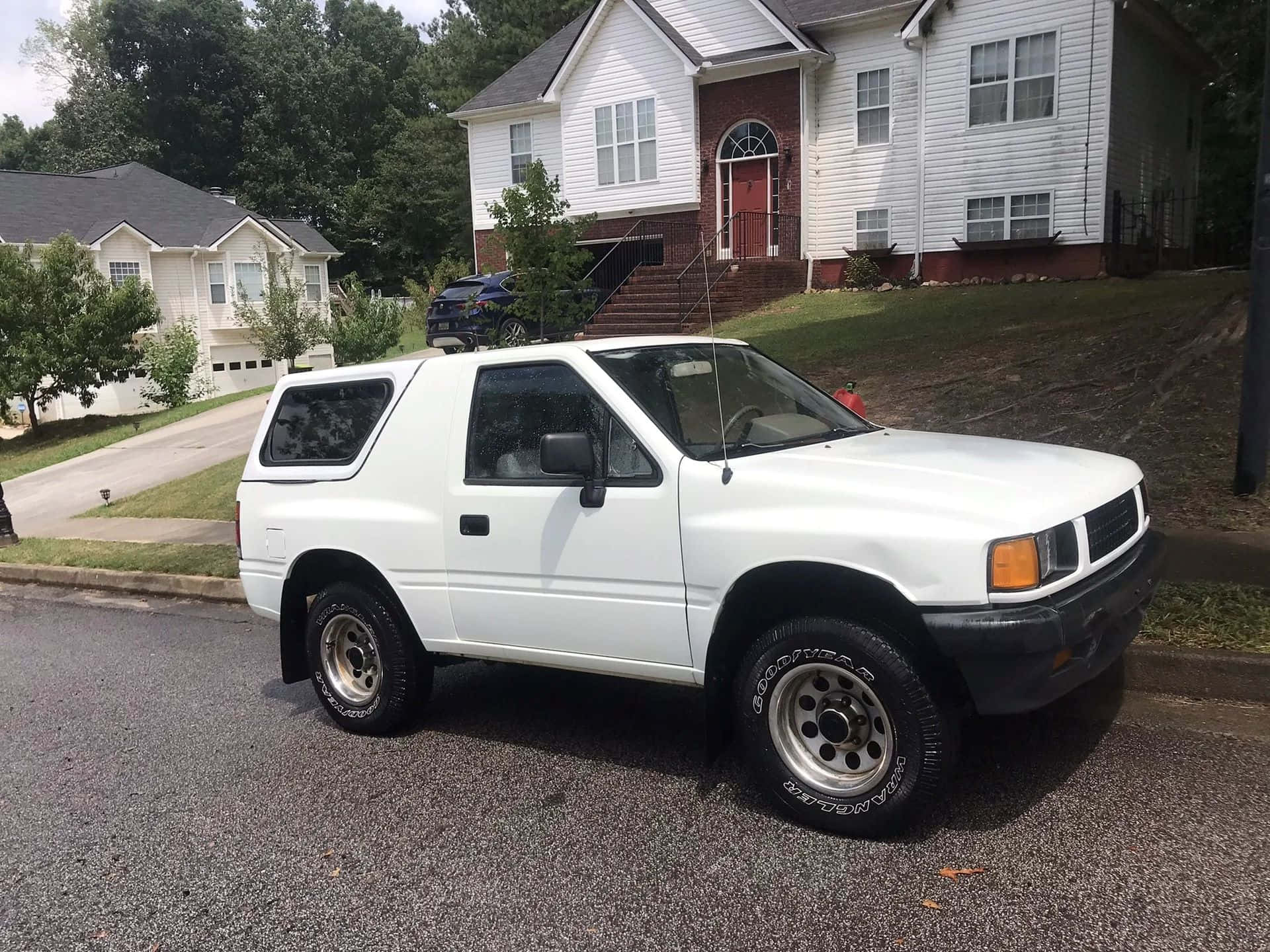 Witte Isuzu Amigo Suburbane Setting Achtergrond