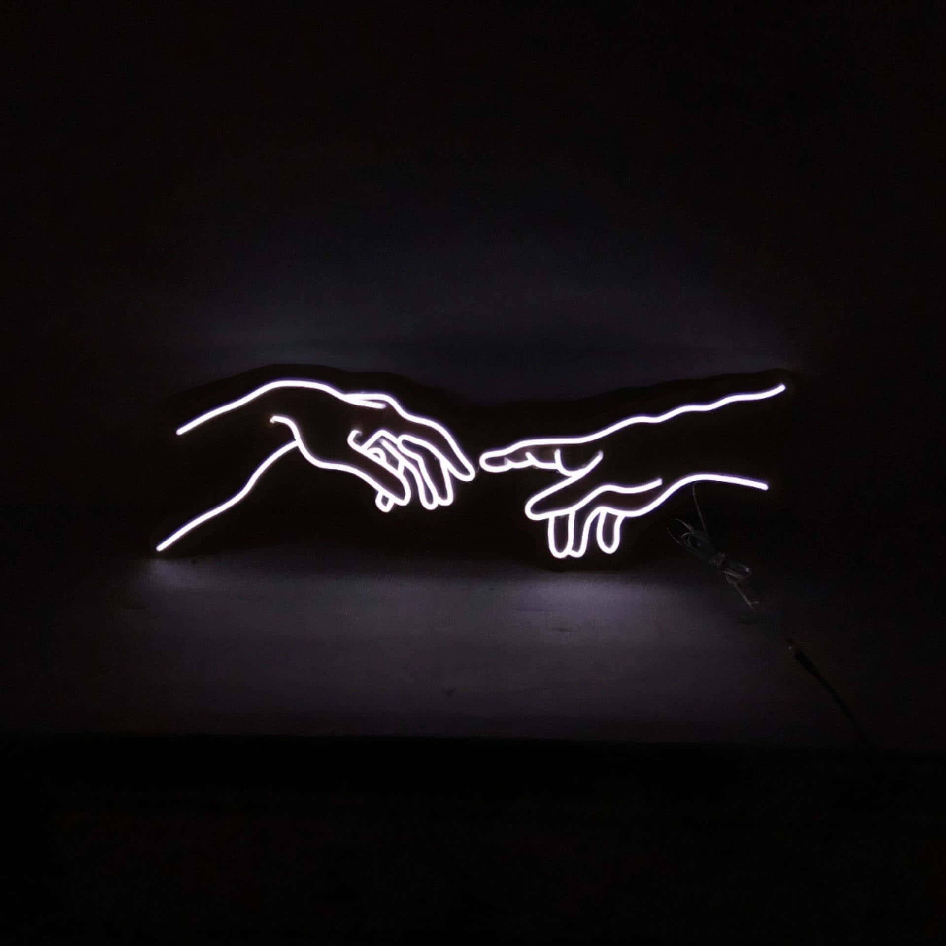 a neon sign showing the creation of adam Wallpaper