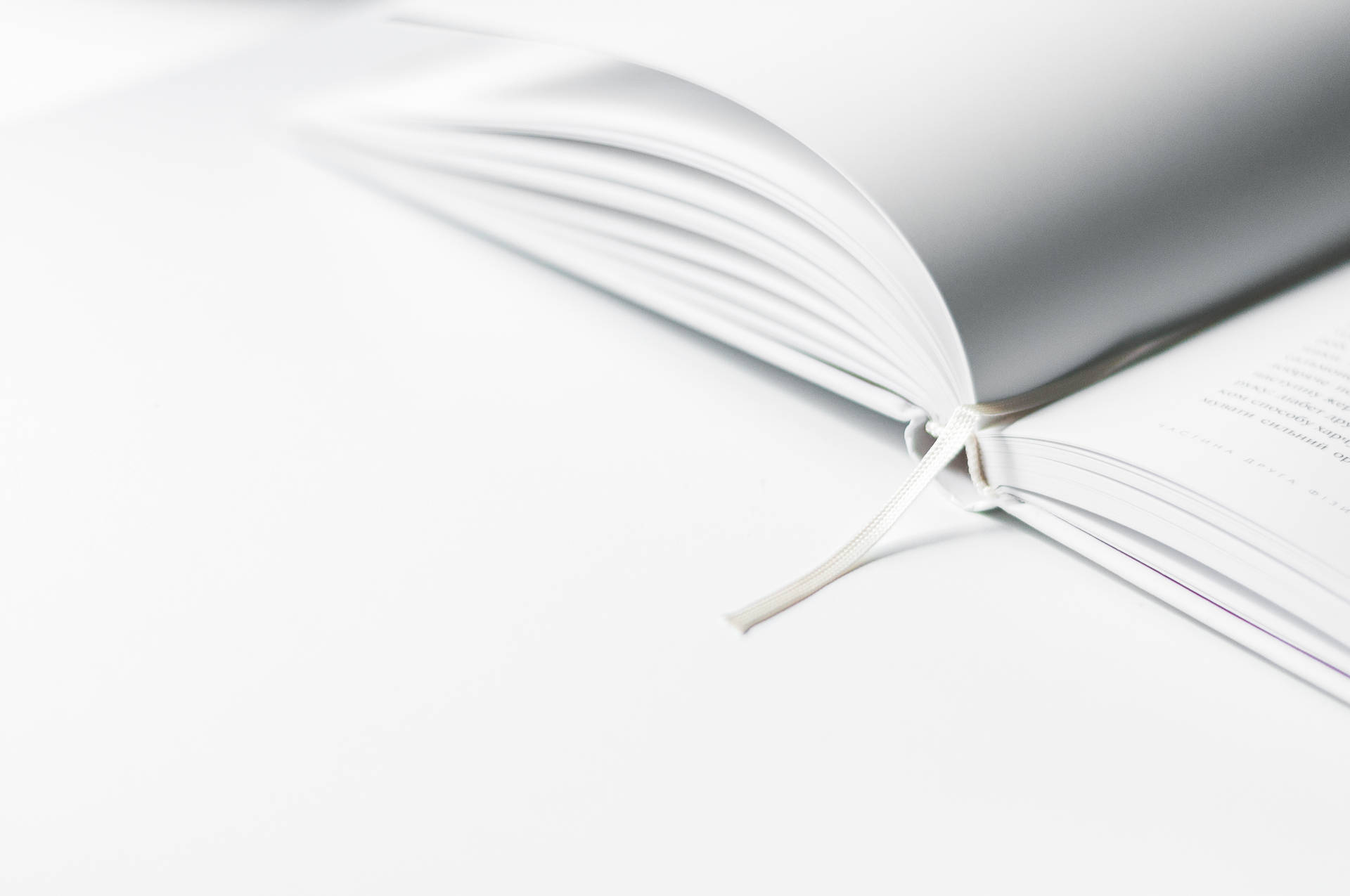 Minimalist wallpaper of white Opened Book With Marker 