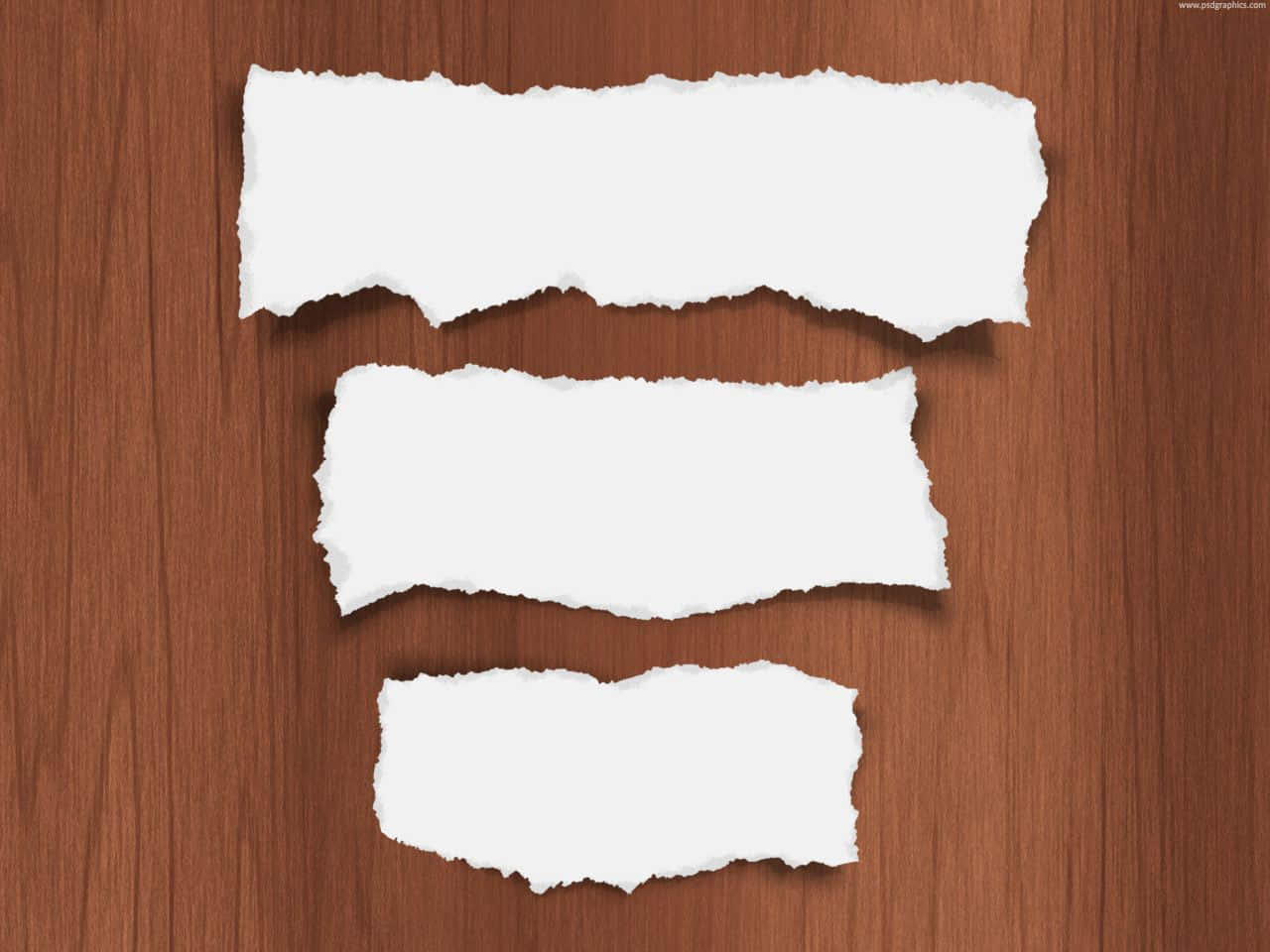 Three Pieces Of Paper On A Wooden Background