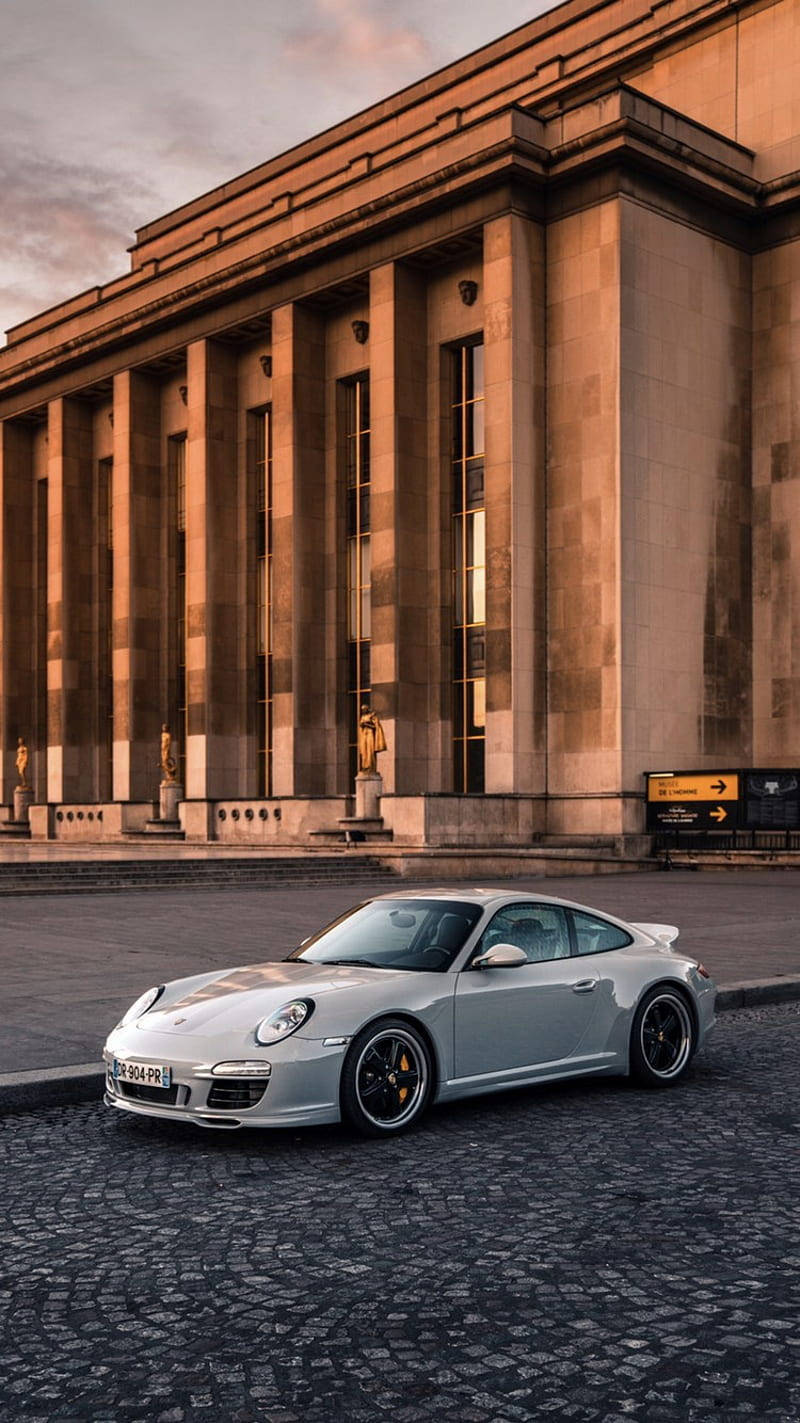 White Porsche 911 Outside Homme Museum Wallpaper