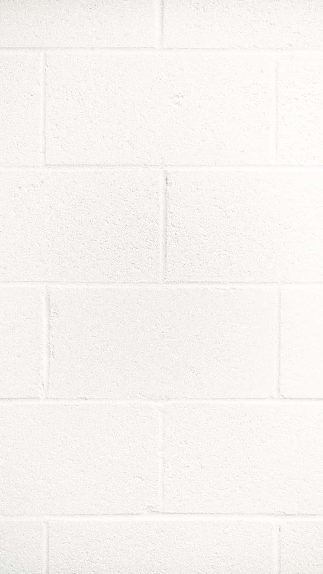 Hvid væg baggrund med mursten mønster