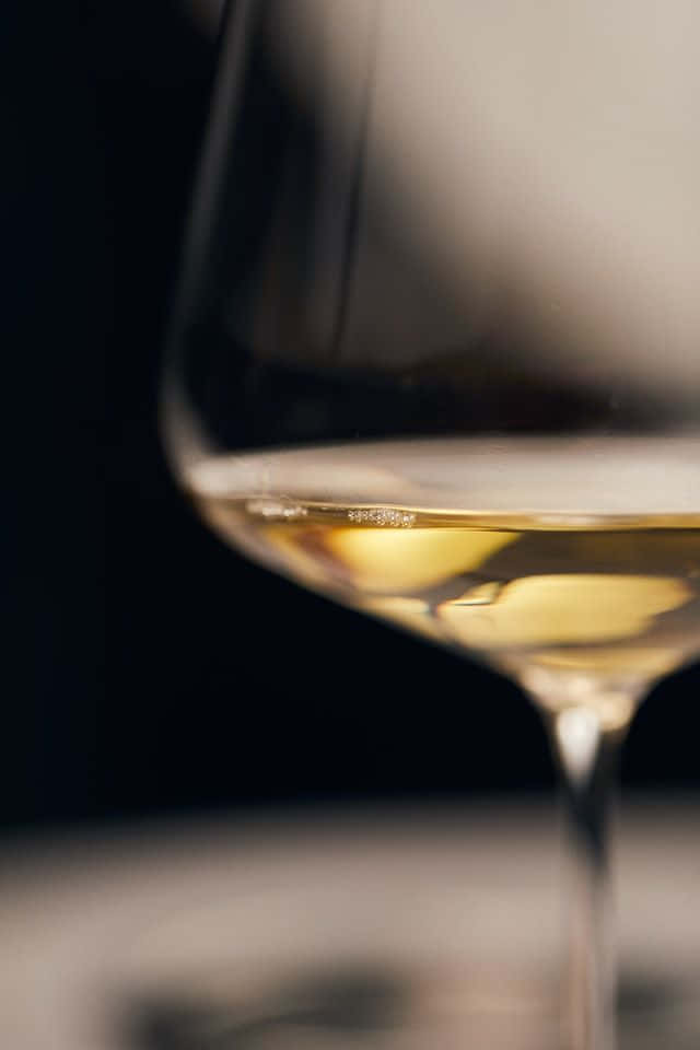 Enjoy a glass of white wine for an evening of relaxation Wallpaper