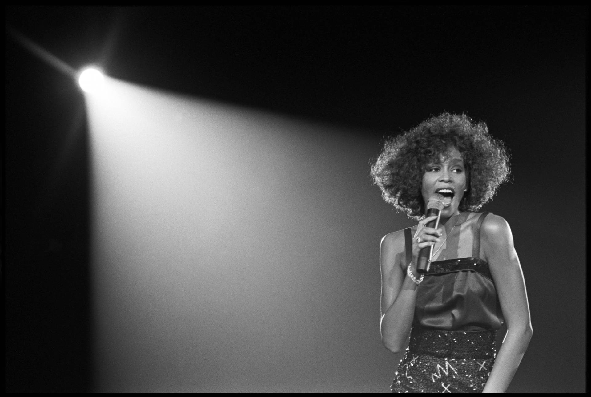 Whitney Houston Under The Spotlight Background