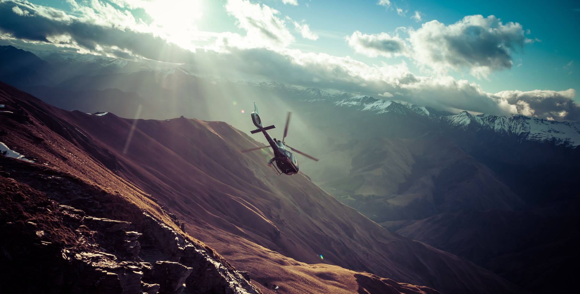 Widescreen Helicopter In The Mountains Wallpaper