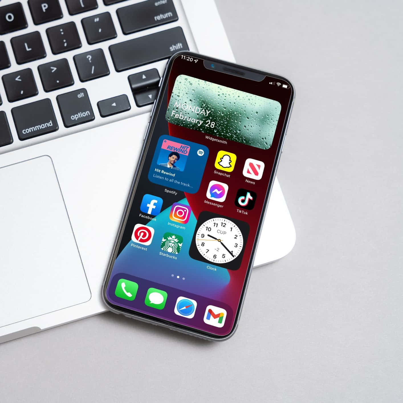 An Iphone Xr With Apps On It Sitting Next To A Laptop