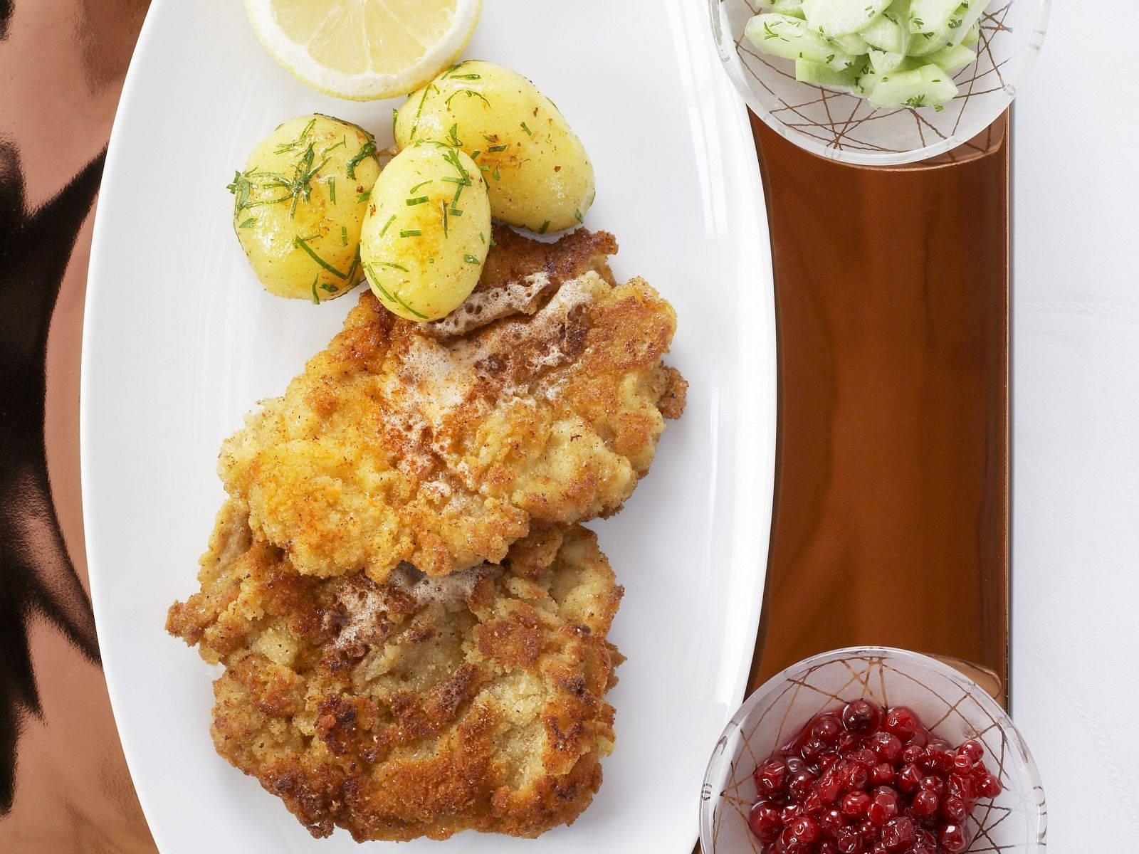 Caption: Delectable Wiener Schnitzel served with tasty Marble Potatoes Wallpaper