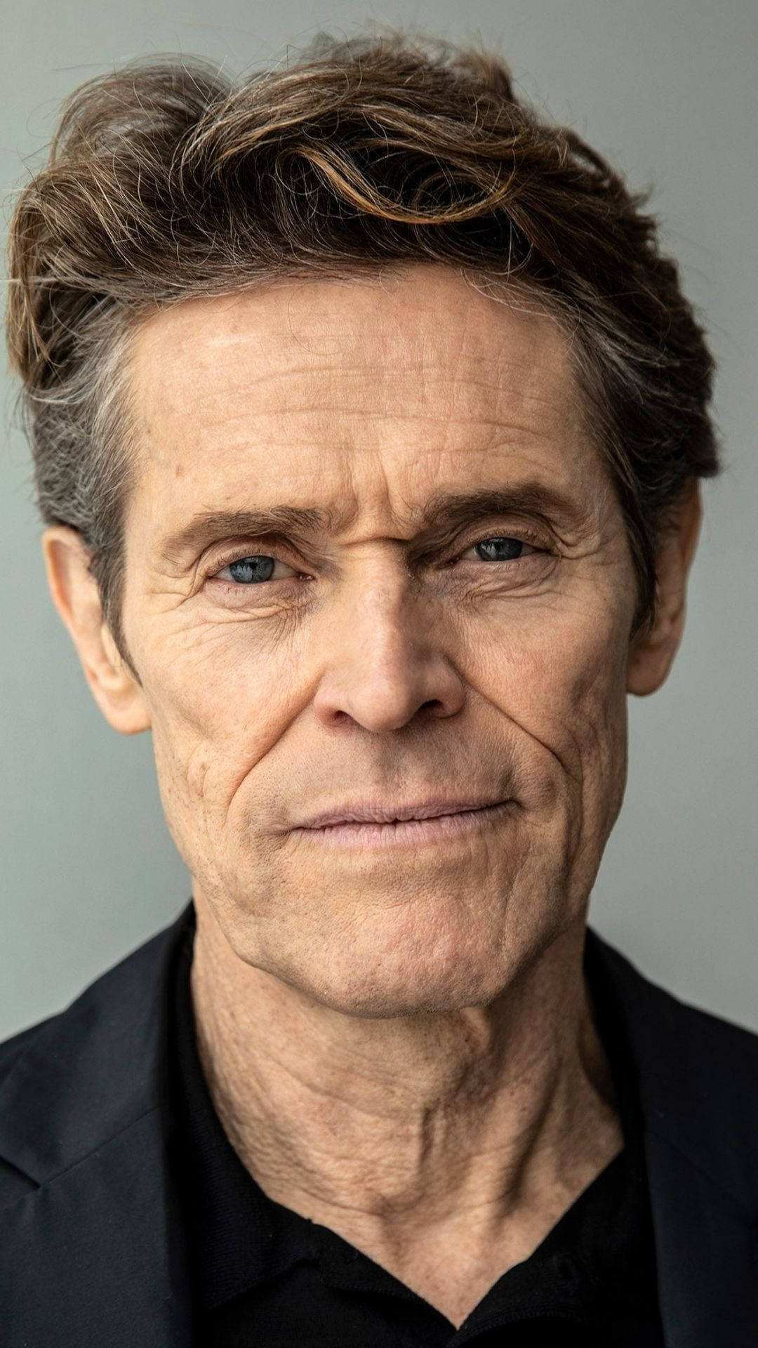 Acclaimed Actor Willem Dafoe in a Close-Up Portrait Wallpaper