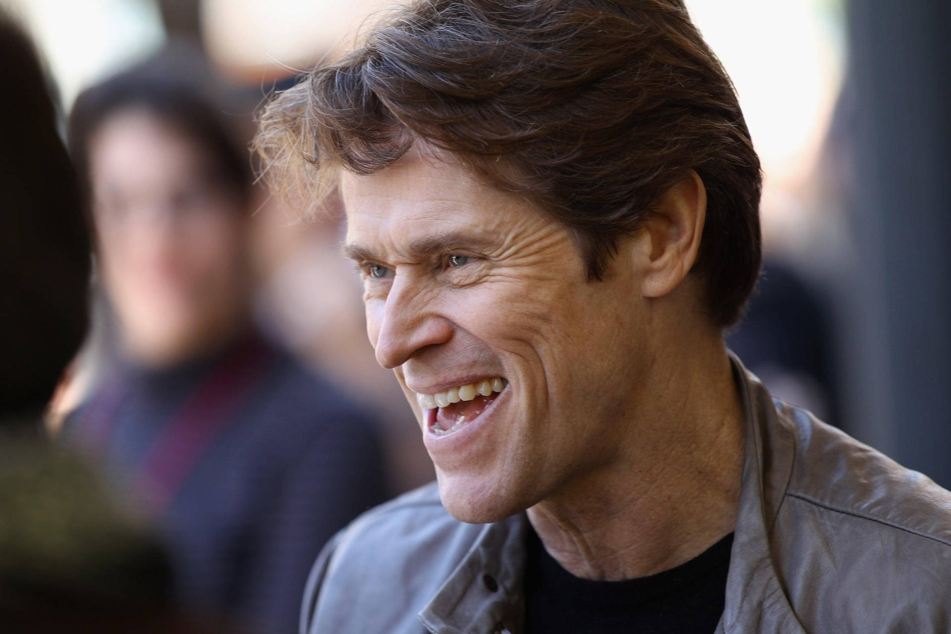 Award-Winning Actor Willem Dafoe in a captivating side profile view. Wallpaper