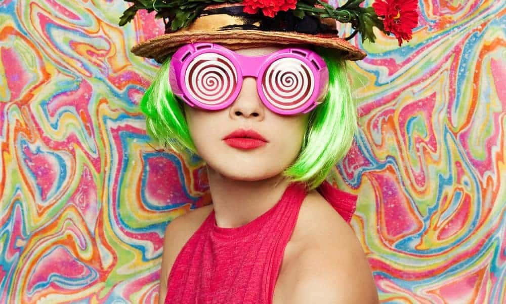 A Woman With Green Hair And Pink Sunglasses