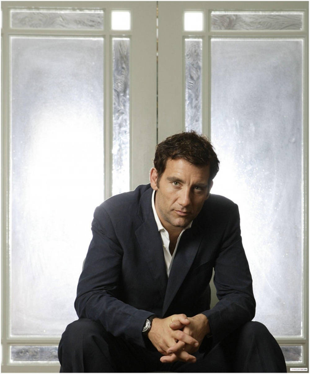 A reflective Clive Owen staring out of the window Wallpaper