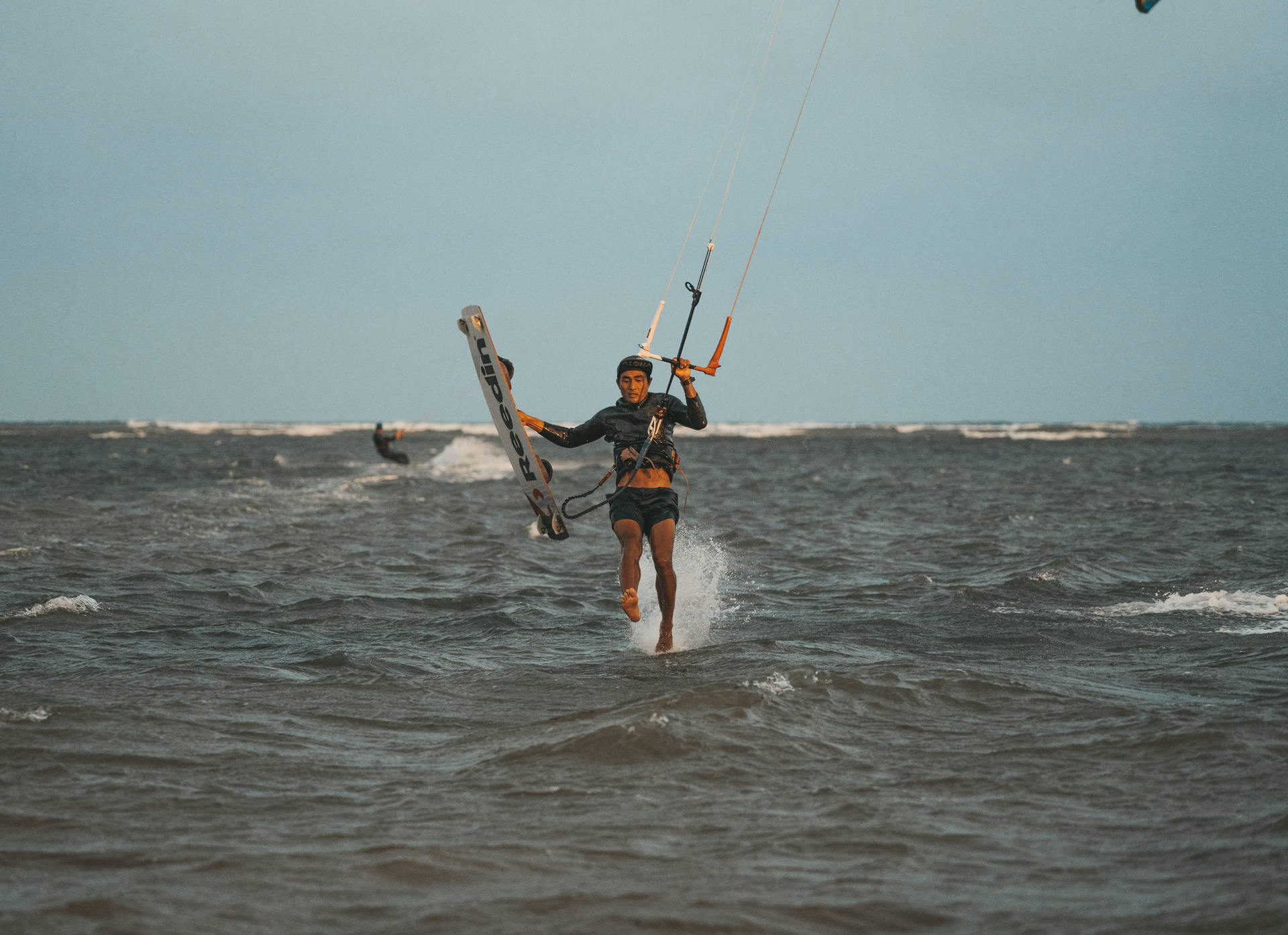 Windsurfing And Walking In Ocean