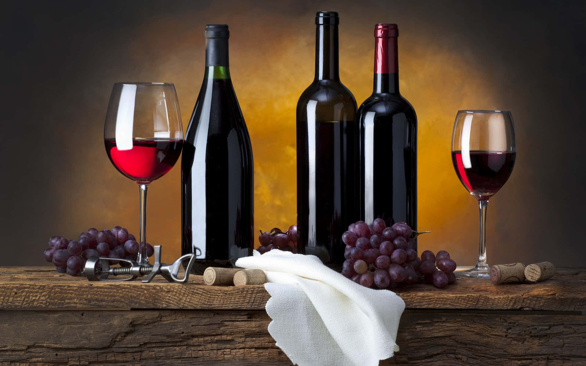 Premium Photo | A bottle of red wine, a glass and grapes on a dark  background.