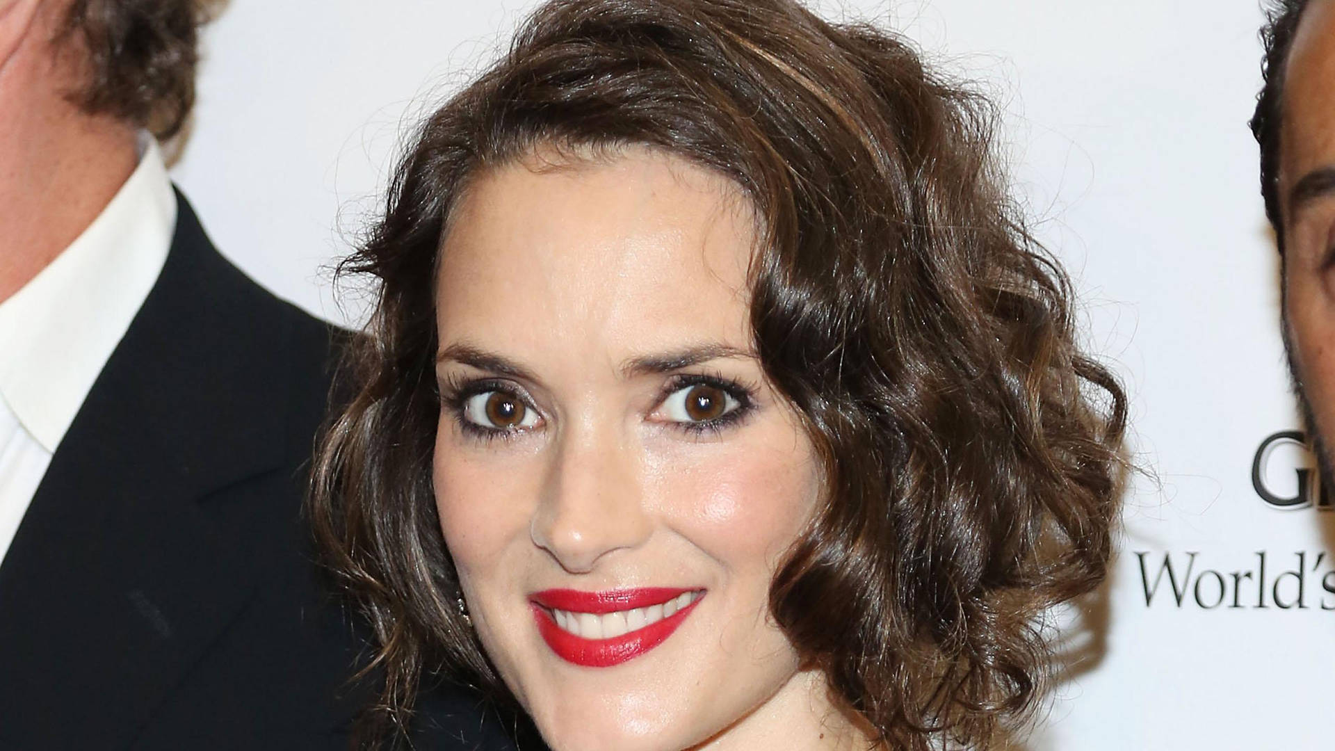 Stunning Winona Ryder sporting red lipstick and a curly short hairdo Wallpaper