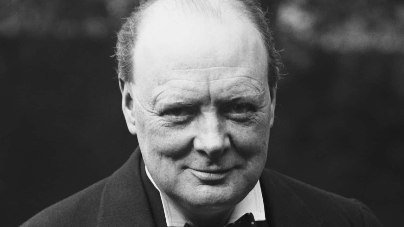 A Black And White Photo Of A Man In A Suit