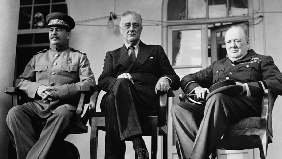 Three Men In Military Uniforms Sitting On Chairs