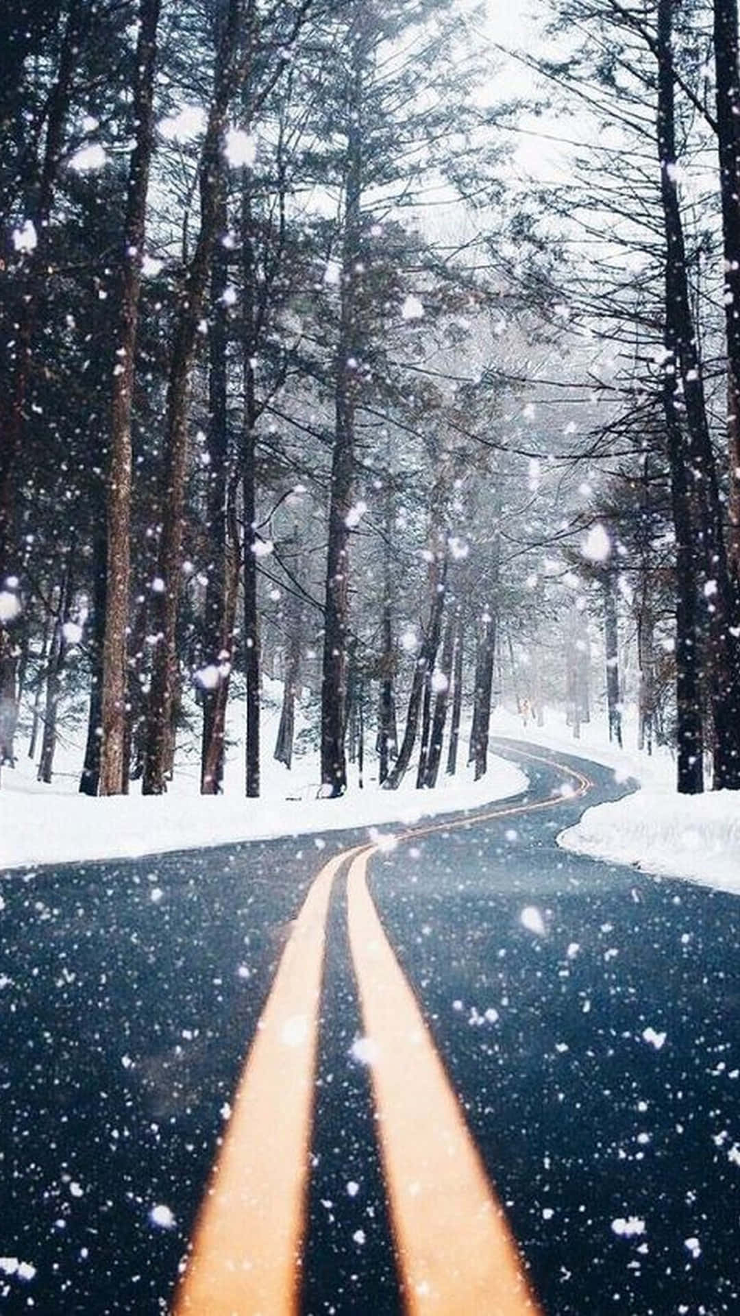 A Road In The Snow With Trees In The Background Wallpaper