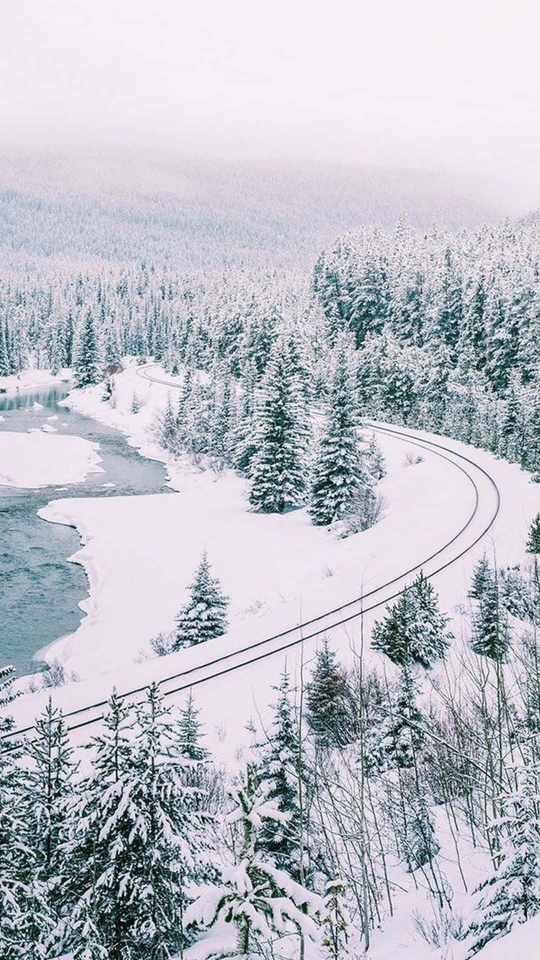 A Snow Covered Road And A River Wallpaper