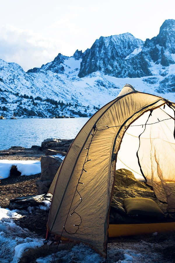 A cozy winter campsite under the stars Wallpaper