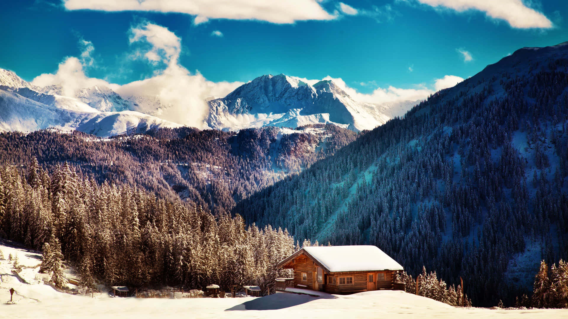 Winter_ Cottage_ Amidst_ Snowy_ Mountains.jpg Wallpaper