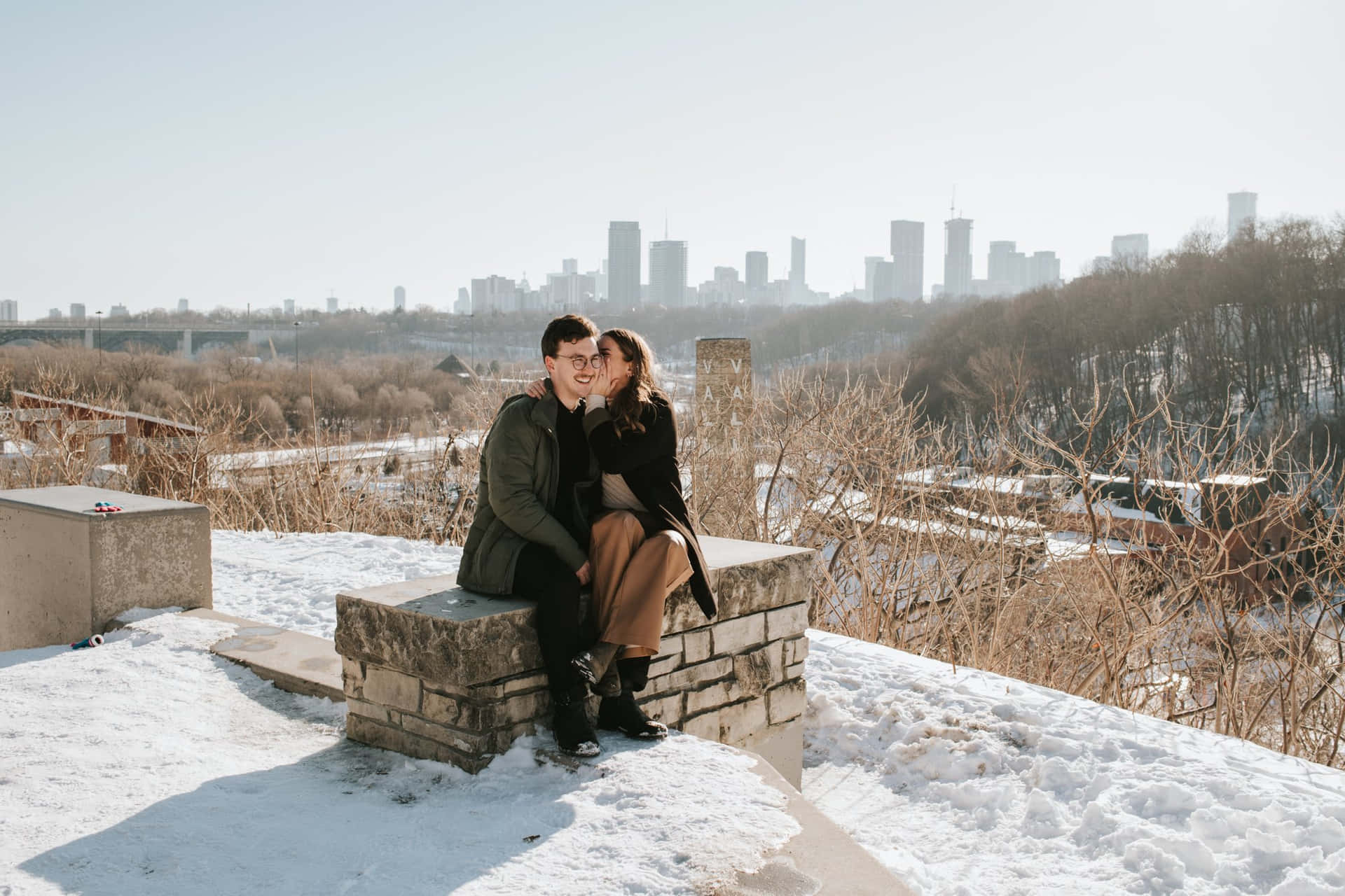 Winter Couple Overlooking City Skyline Wallpaper