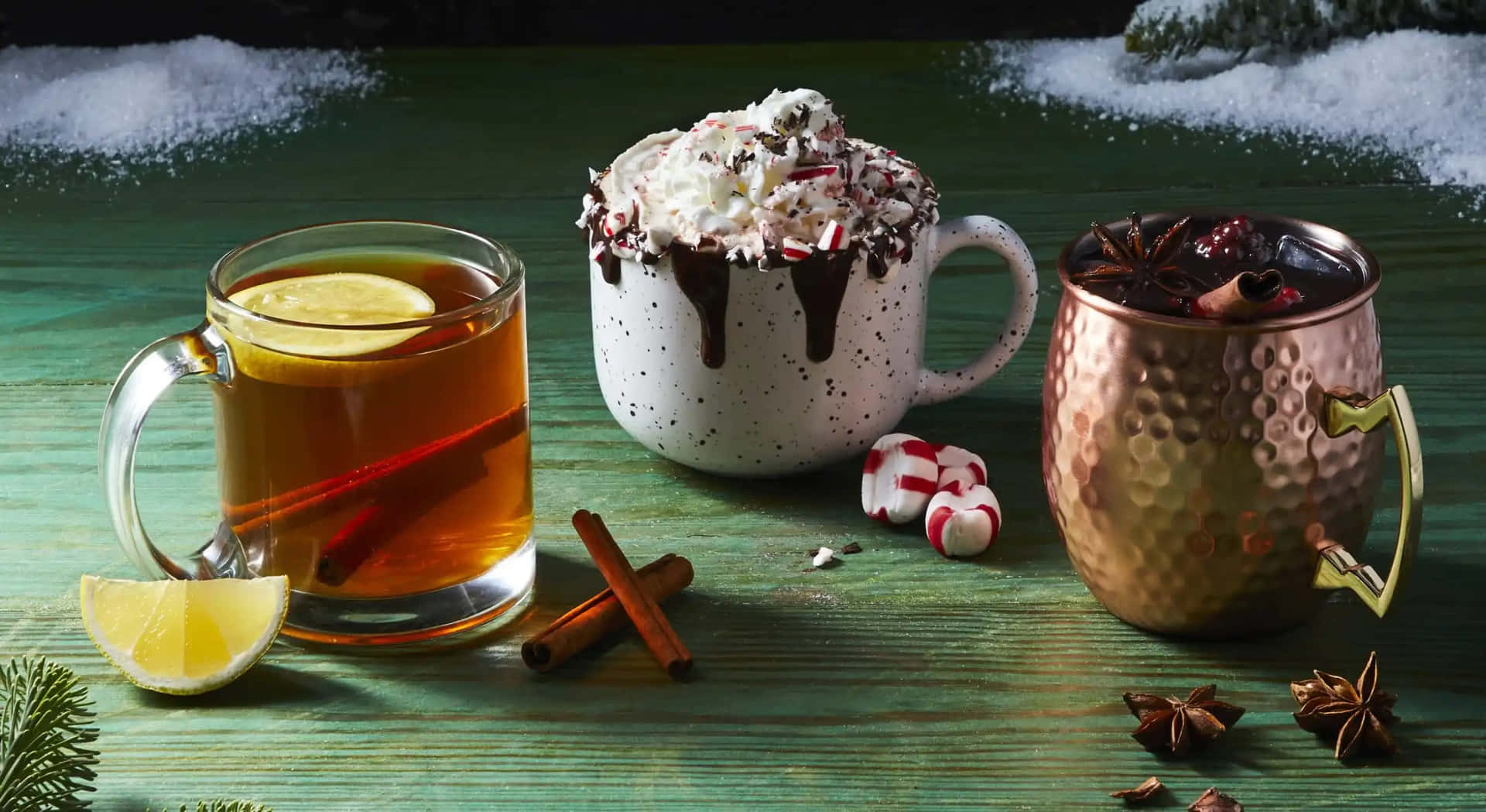 A cozy winter scene with a steaming cup of hot chocolate and cinnamon sticks Wallpaper