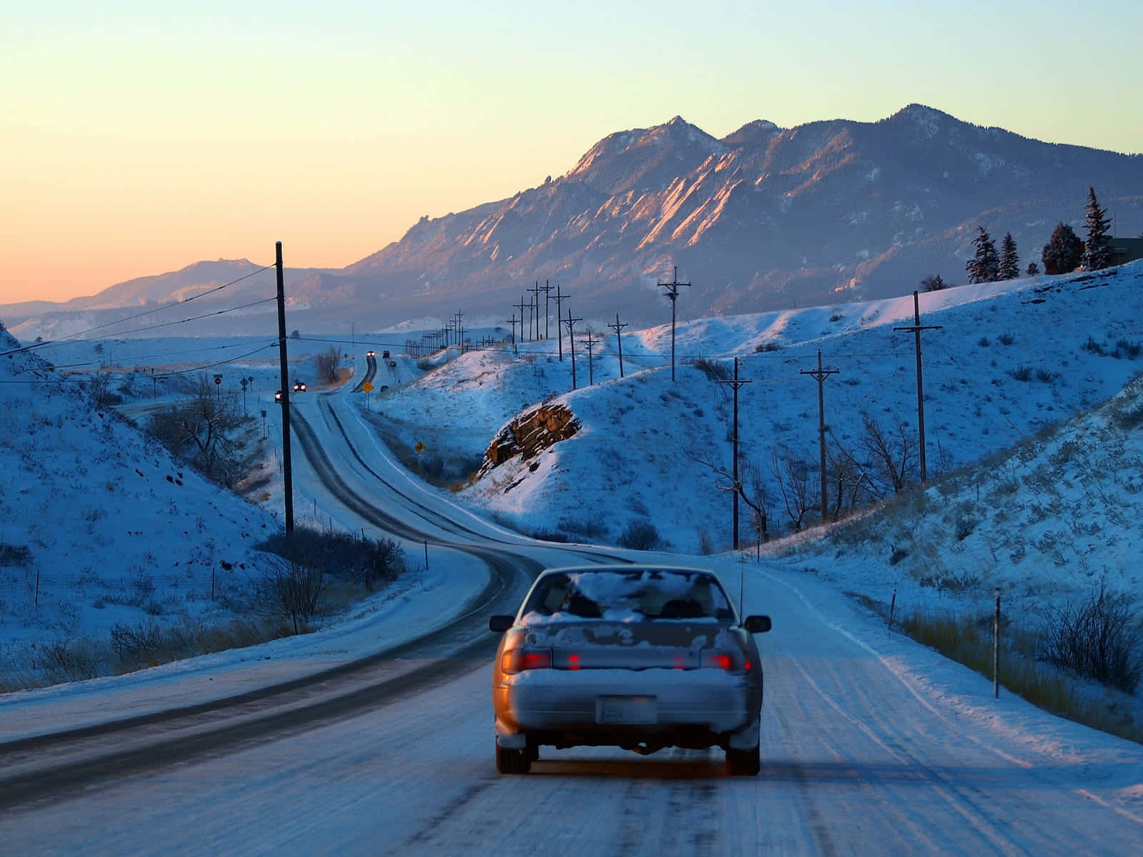 Winter Driving Through Snowy Mountain Road Wallpaper