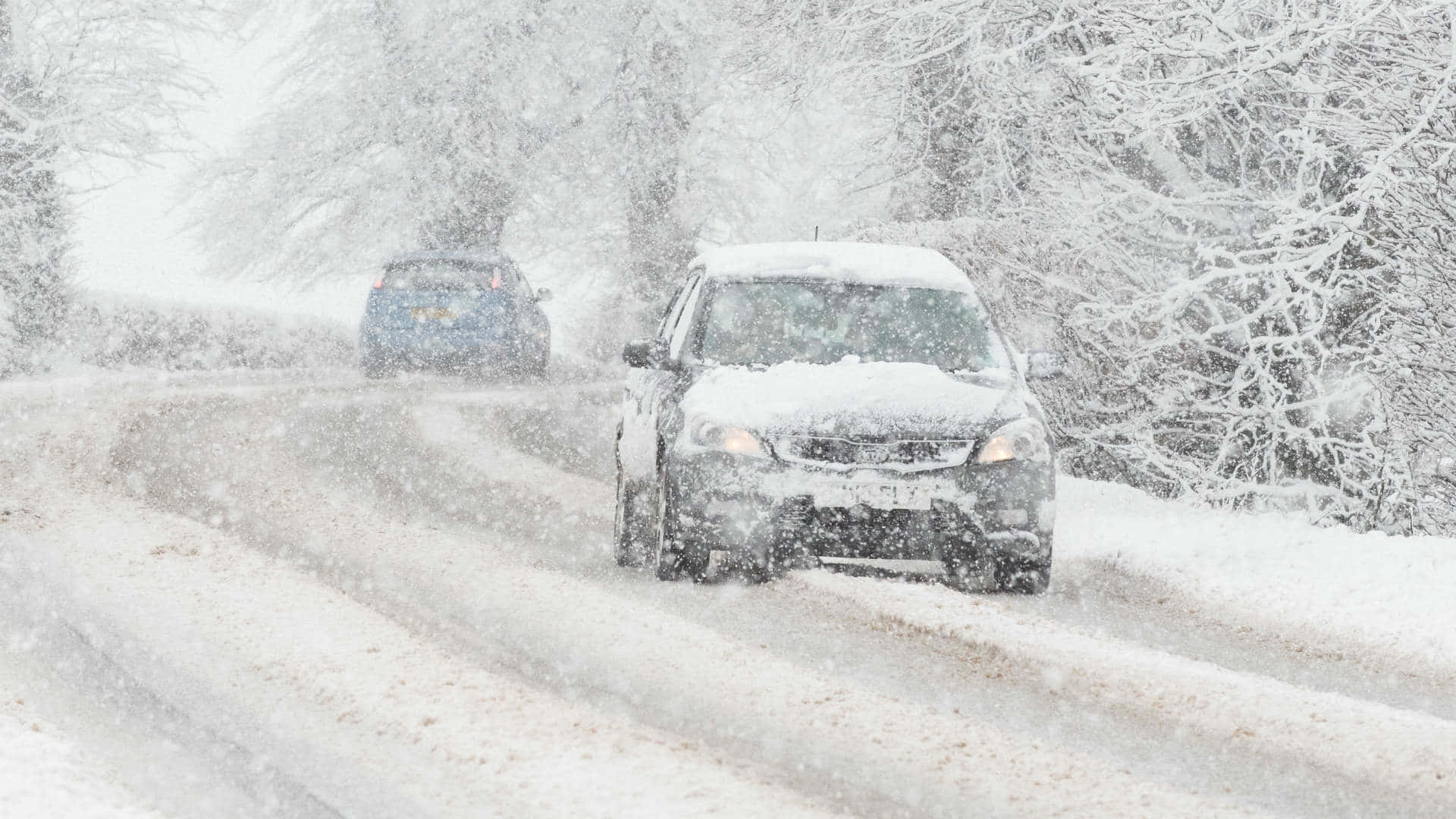 Snowy roads make for difficult driving conditions during winter months. Wallpaper