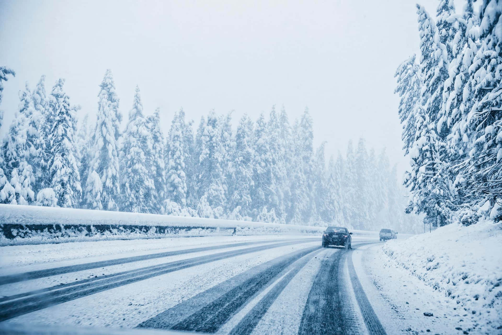 Car driving on snow-covered road in winter Wallpaper