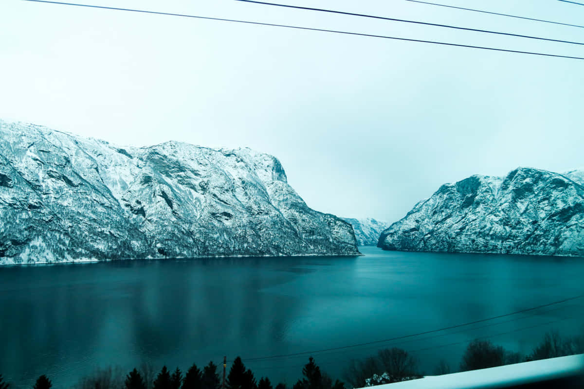 Winter_ Fjord_ Snowy_ Cliffs.jpg Wallpaper