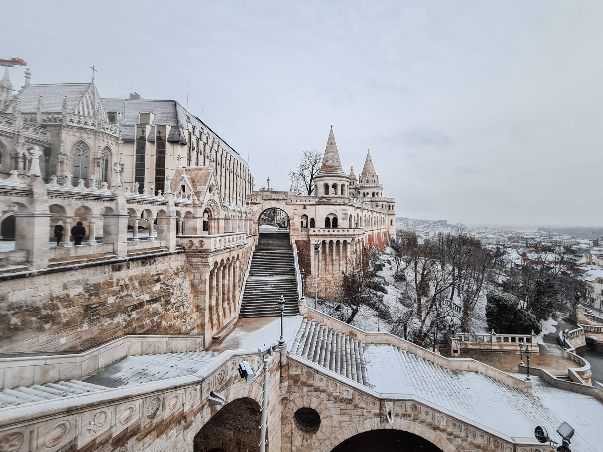 a snow covered castle with a snow covered walkway Wallpaper