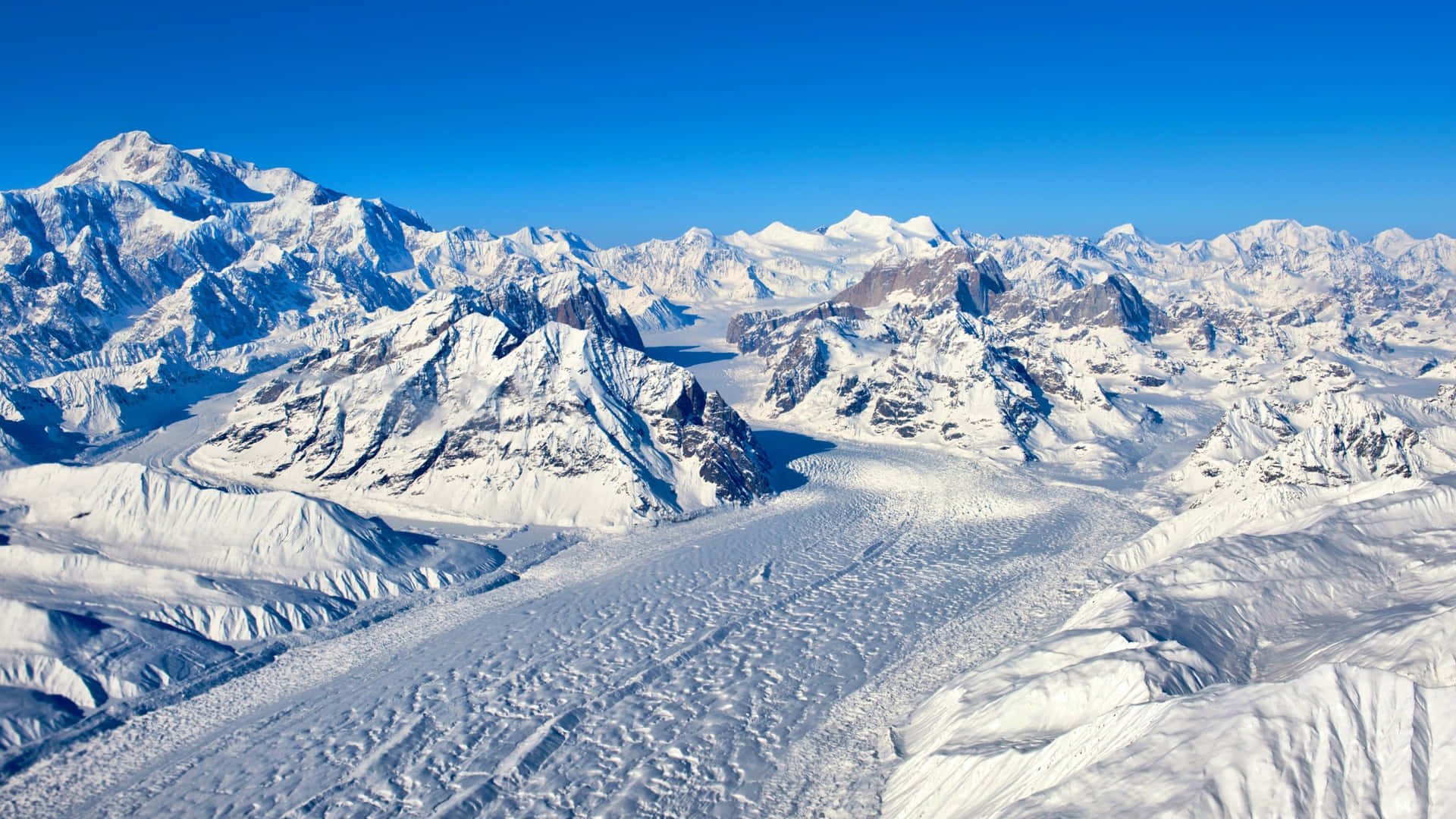 A View Of A Snow Covered Mountain Range Wallpaper