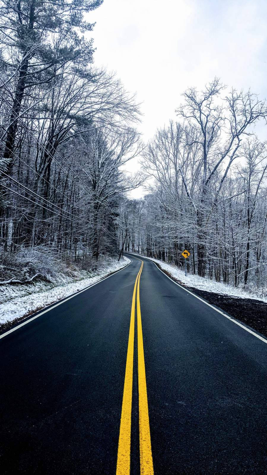 Winter Road Through Snowy Forest.jpg Wallpaper