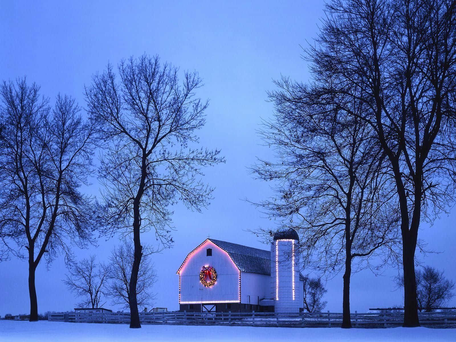 A White Barn Lit Up In The Snow