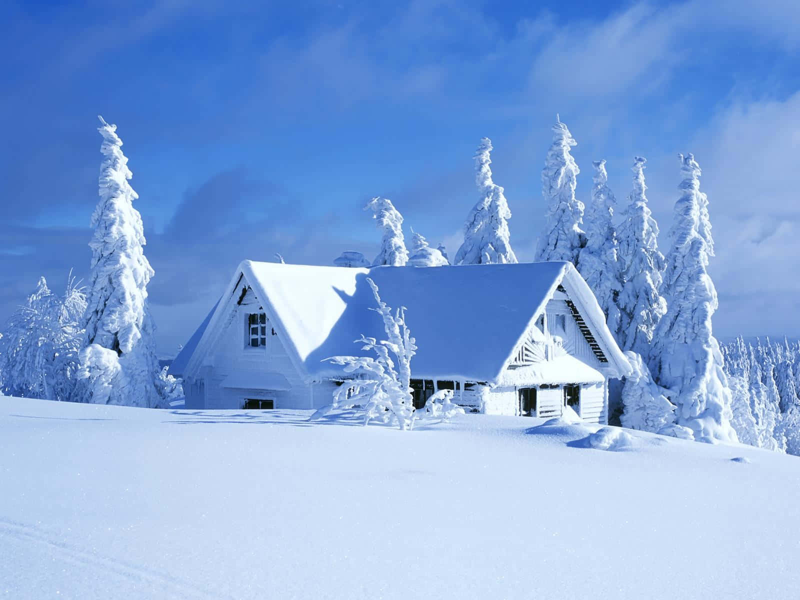 a white house on a snow covered hill