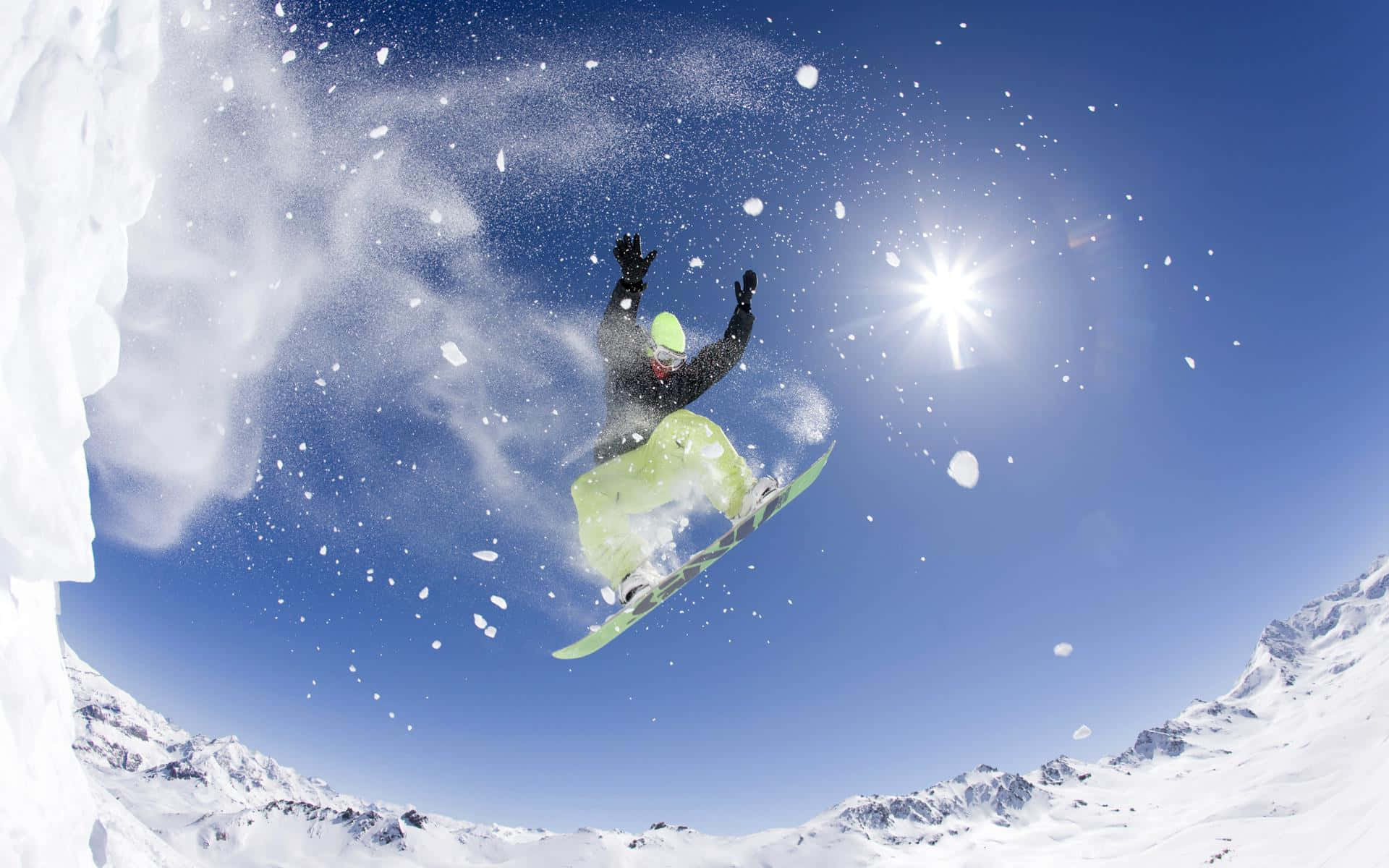 A Group of Friends Enjoying Snowboarding on a Beautiful Winter Day Wallpaper