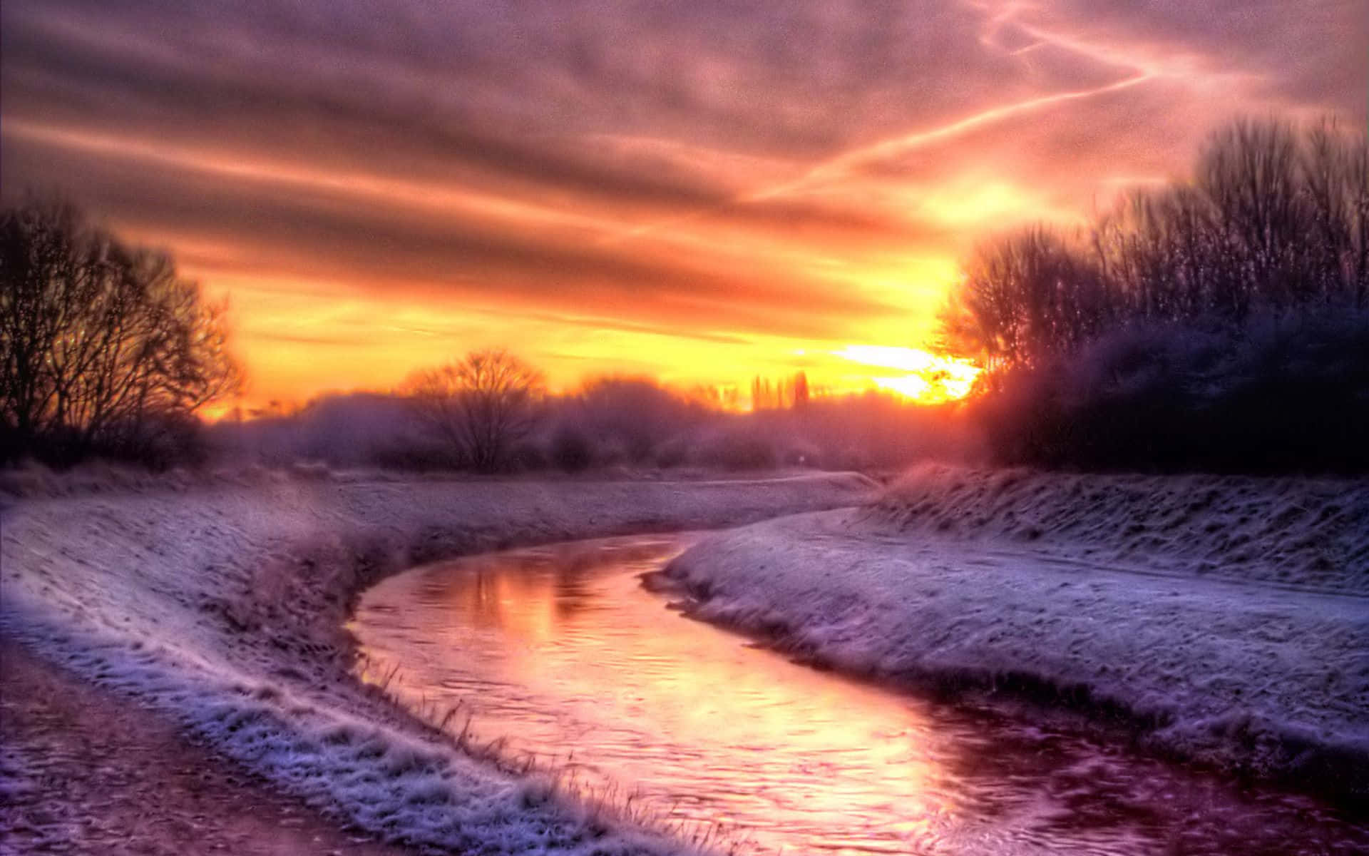 Winter Sunset Over Snowy Landscape Wallpaper