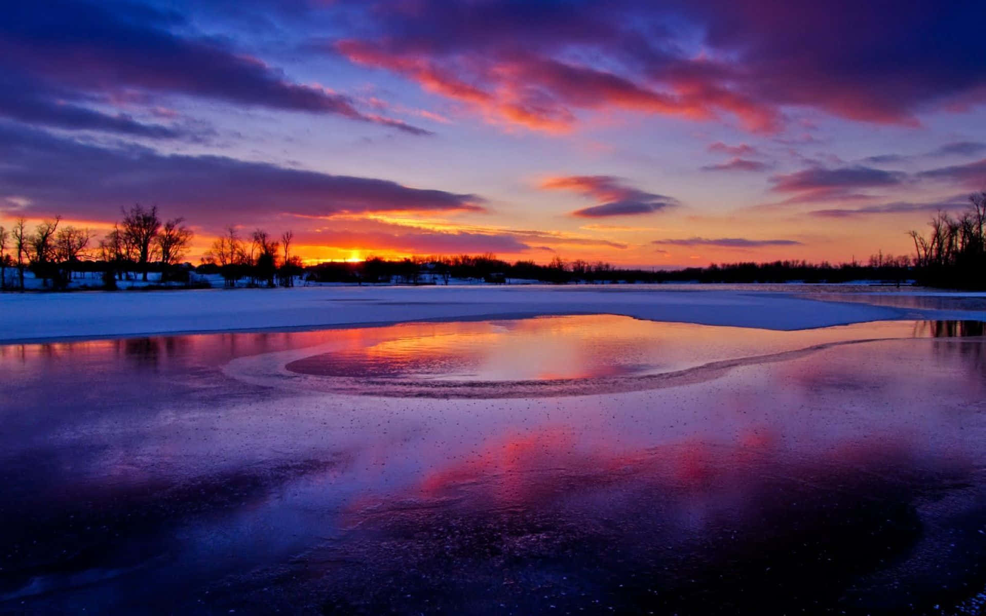 Enchanting Winter Sunset Over Snow-Covered Landscape Wallpaper