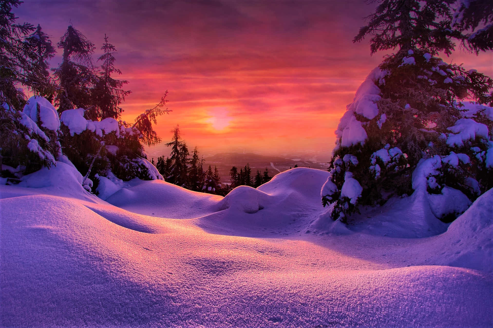 Enchanting Winter Sunset Over Snowy Landscape Wallpaper