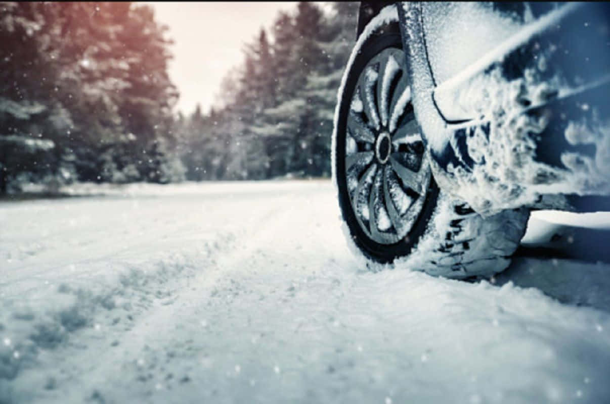 A stack of brand-new winter tires on a snowy background Wallpaper