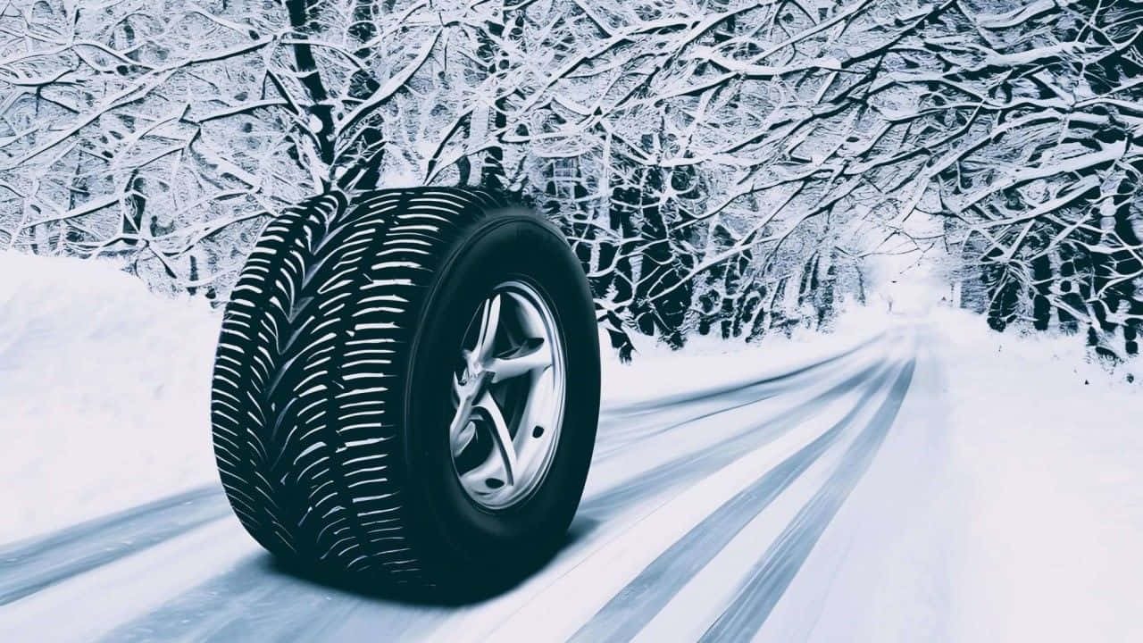 A Set of Winter Tires on Snowy Terrain Wallpaper