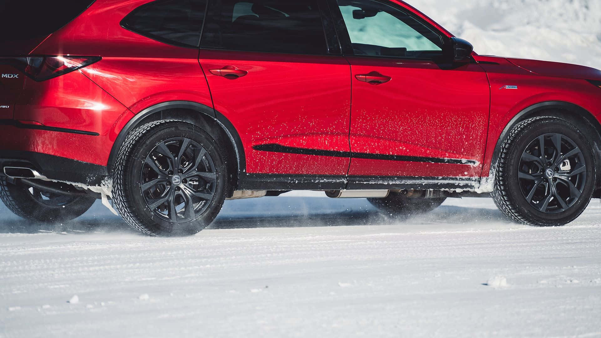 Winter tires in action during heavy snowfall Wallpaper