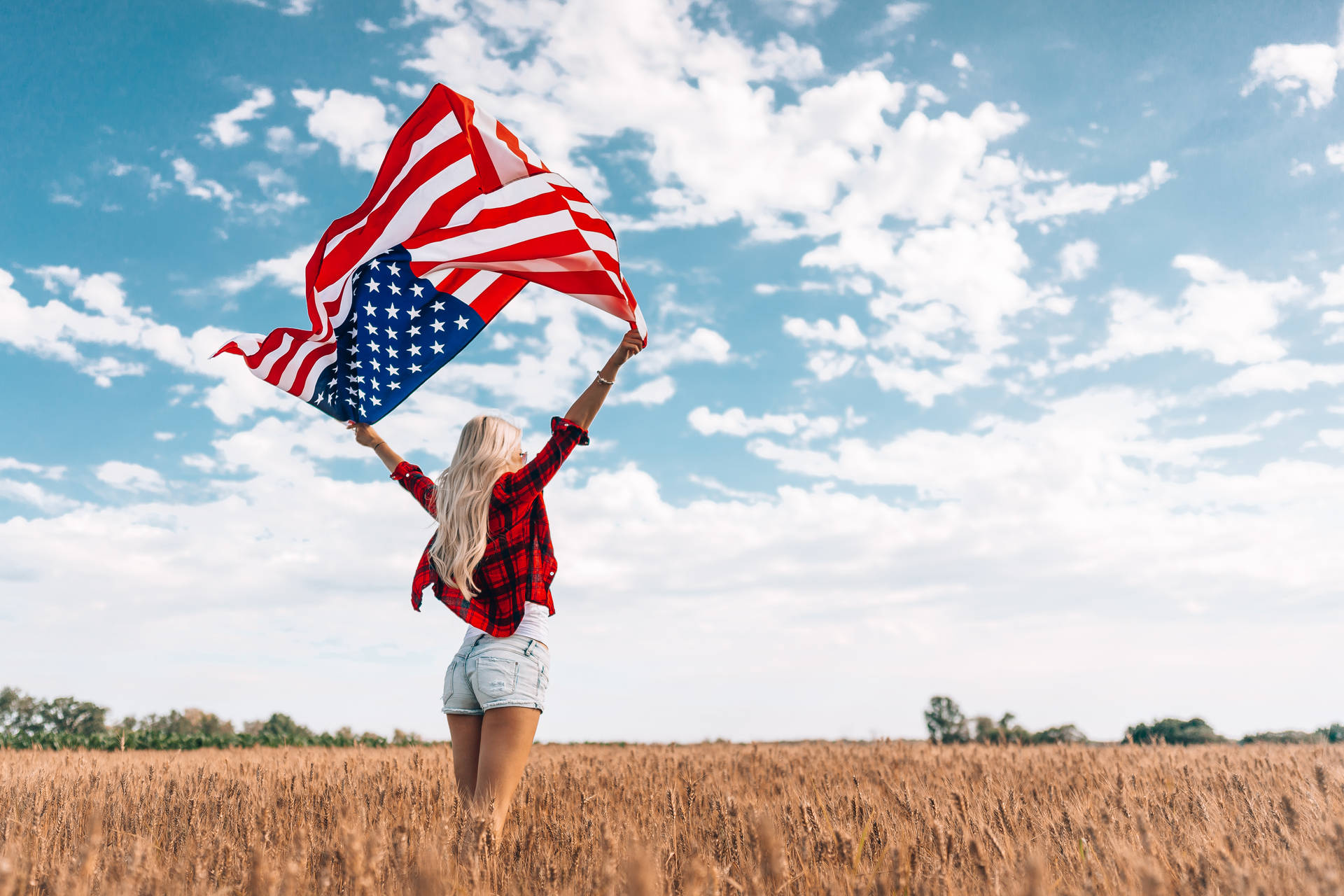 Woman Celebrating Freedom On Field Wallpaper