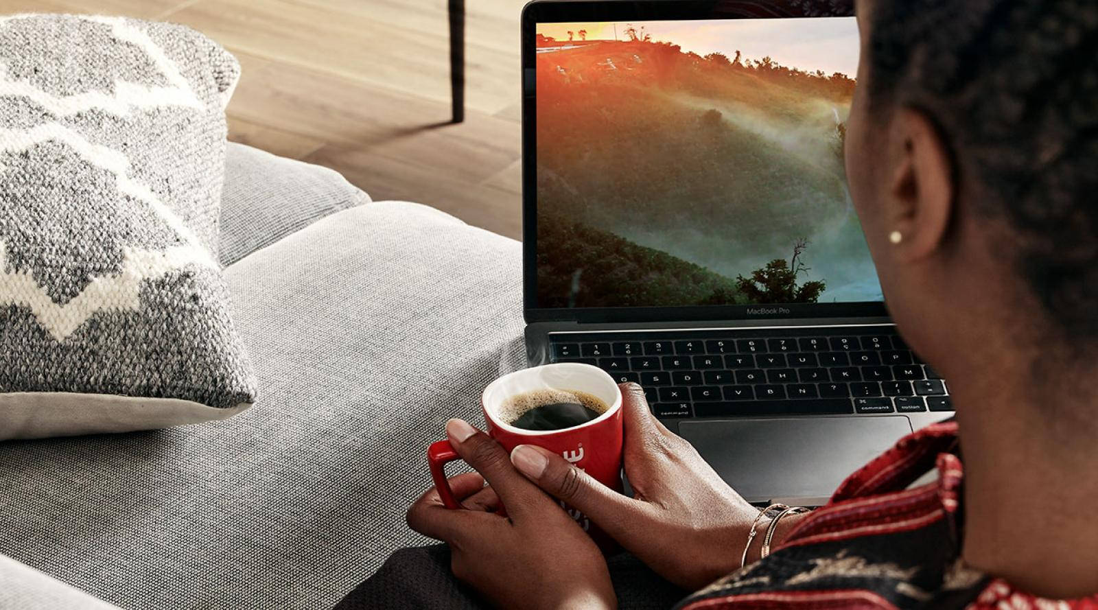 Woman Clasping Coffee While Watching Laptop Background