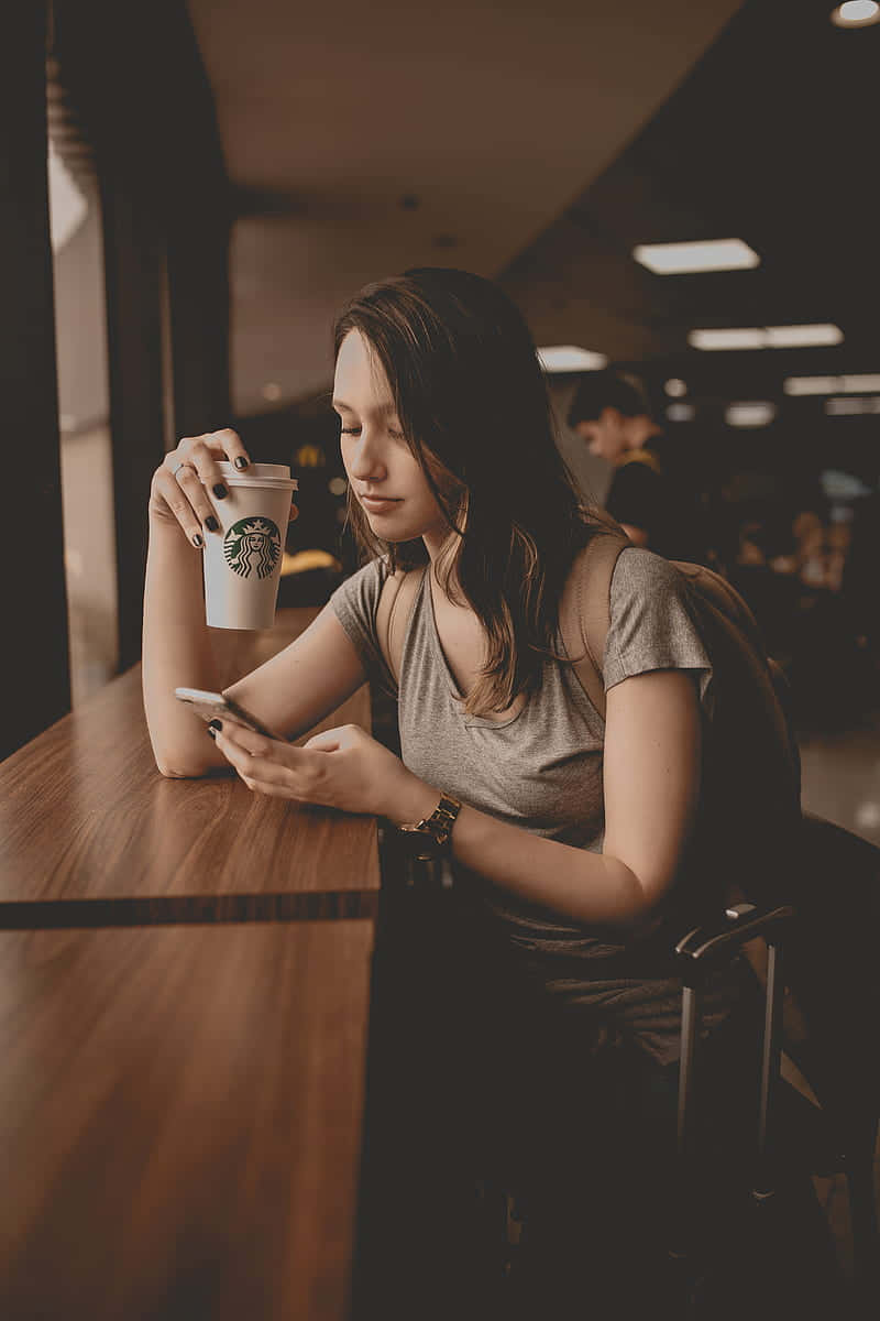 Woman Holding A Disposable Cup Wallpaper