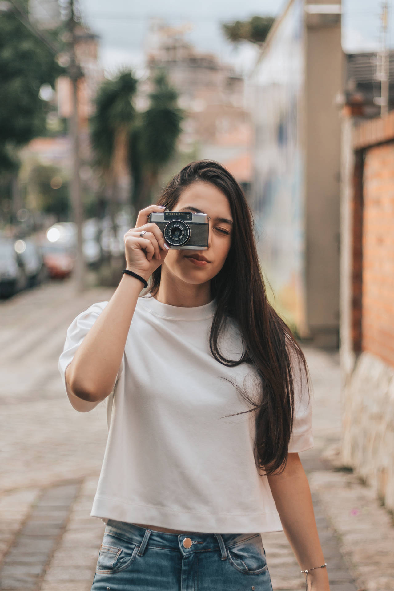 Woman Holding Camera Photo Wallpaper